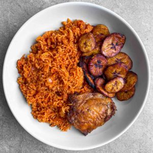 A full plate of jollof rice and fried chicken